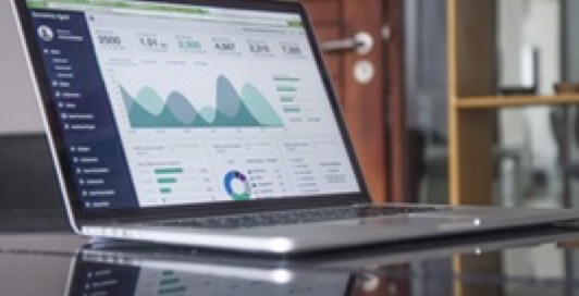 A laptop with dashboard statistic displayed on screen
