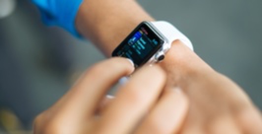 Someone using apple watch wrapped around their wrist