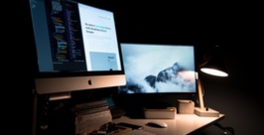 Two computer screen on a table